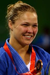 BEIJING - AUGUST 13:  Bronze medalist Ronda Rousey of the USA stands on the podium during the medal ceremony for the Women's 70 kg judo competition at the University of Science and Technology Gymnasium during Day 5 of the Beijing 2008 Olympic Games on August 13, 2008 in Beijing, China.  (Photo by Mike Hewitt/Getty Images)